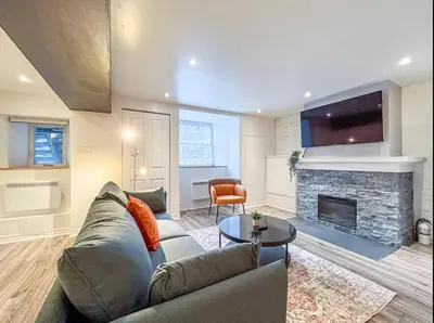 a living room with a couch and a fireplace at Elegant 1BR Suite - Washer & Dryer - Prime Location in Montréal
