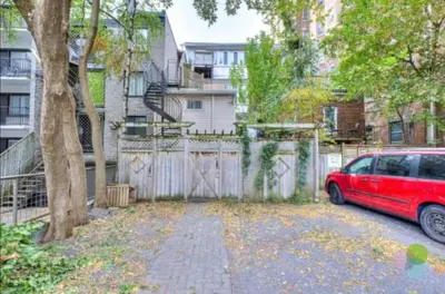 a red car parked in front of a fence at Elegant 1BR Suite - Washer & Dryer - Prime Location in Montréal