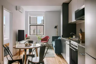 a kitchen and dining room with a table and chairs at The Alexander Hotel - Old Montreal in Montréal