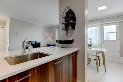 a kitchen with a sink and a counter top at Refined Downtown 1BR Suite - Luxury Comfort in Montréal