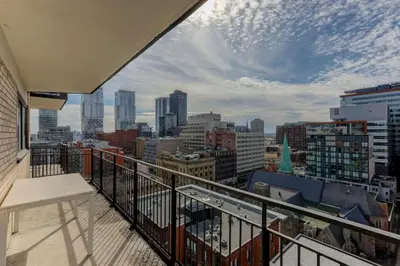 a balcony with a view of a city at Refined Downtown 1BR Suite - Luxury Comfort in Montréal