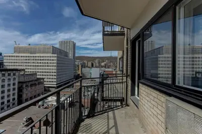 a balcony with a view of a city at Refined Downtown 1BR Suite - Luxury Comfort in Montréal