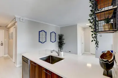 a kitchen with a sink and a white counter top at Refined Downtown 1BR Suite - Luxury Comfort in Montréal