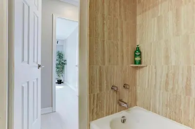 a bathroom with a bath tub and a sink at Refined Downtown 1BR Suite - Luxury Comfort in Montréal