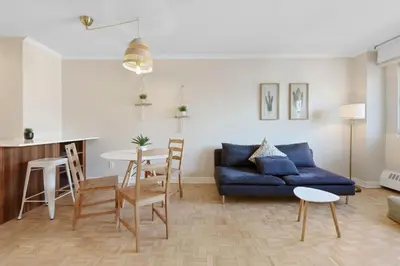 a living room with a blue couch and a table at Luxury Downtown 1BR Residence - Urban Comfort in Montréal