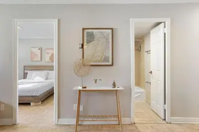 a bedroom with a bed and a table and a mirror at Luxury Downtown 1BR Residence - Urban Comfort in Montréal