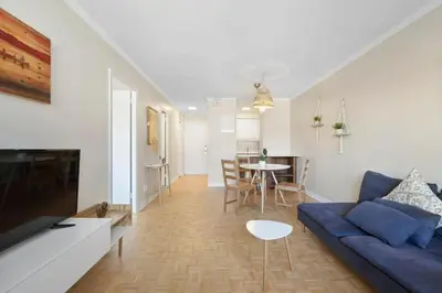 a living room with a blue couch and a table at Luxury Downtown 1BR Residence - Urban Comfort in Montréal