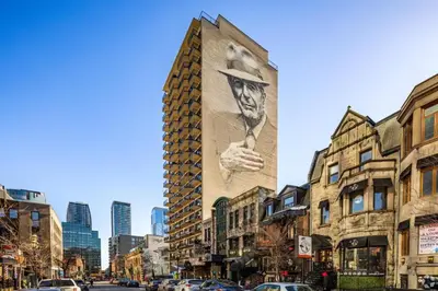 a building with a large advertisement on the side of it at Luxury Downtown 1BR Residence - Urban Comfort in Montréal