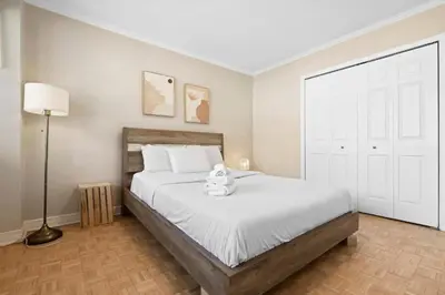 a bedroom with a bed with a teddy bear on it at Luxury Downtown 1BR Residence - Urban Comfort in Montréal