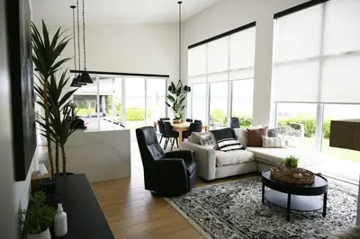 a living room with a couch and a table at Spa & Comfort - Chalet KG Petit lac Lambton in Lambton