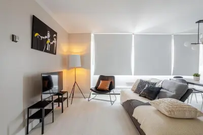 a living room with a couch and a tv at Modern 1BR Downtown Suite - High-Speed Wi-Fi in Montréal
