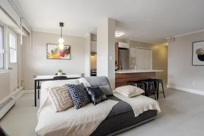 a living room with a bed and a kitchen at Modern 1BR Downtown Suite - High-Speed Wi-Fi in Montréal