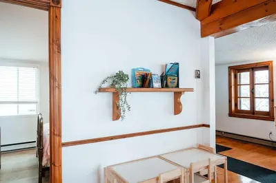 a living room with a bench on the wall at Le Repere du Lac - Lake View Access & Spa in Venise-en-Québec