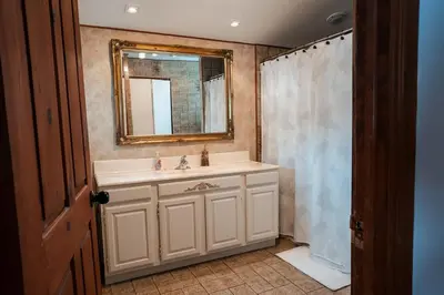 a bathroom with a sink and a mirror at Le Repere du Lac - Lake View Access & Spa in Venise-en-Québec