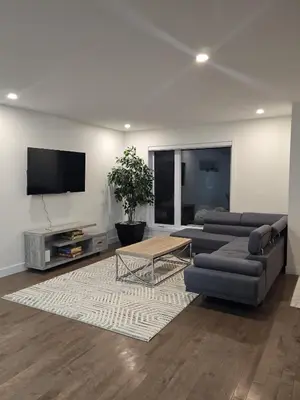 a living room with two couches and a tv at Spacious 4 Bedroom Family Retreat, Minutes from Montréal in Longueuil