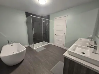 a bathroom with a sink and a shower and a toilet at Spacious 4 Bedroom Family Retreat, Minutes from Montréal in Longueuil