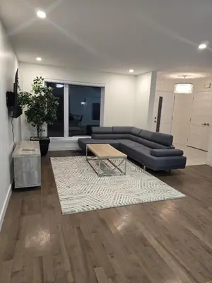 a living room with a couch and a coffee table at Spacious 4 Bedroom Family Retreat, Minutes from Montréal in Longueuil