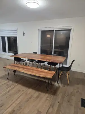 a wooden table with chairs and a bench in a room at Spacious 4 Bedroom Family Retreat, Minutes from Montréal in Longueuil