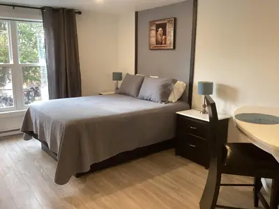 a bedroom with a bed and a desk and a window at Bethel in Sherbrooke