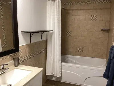 a bathroom with a white tub and a sink at Bethel in Sherbrooke