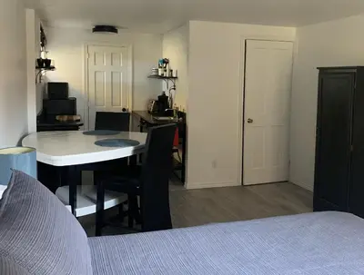 a room with a table and chairs and a kitchen at Bethel in Sherbrooke