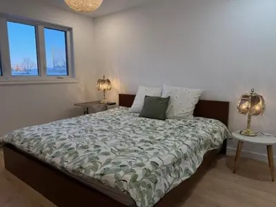 a bedroom with a bed and two lamps on tables at Apartment with 3 bedrooms for long stays in Montréal