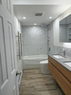 a bathroom with a tub and a toilet and a sink at Apartment with 3 bedrooms for long stays in Montréal
