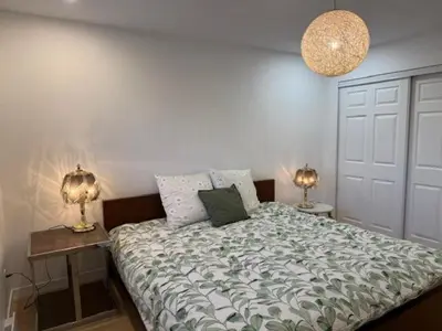 a bedroom with a bed with two lamps on it at Apartment with 3 bedrooms for long stays in Montréal