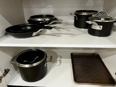 three pots and pans on a stove in a kitchen at Edinburgh in Drummondville