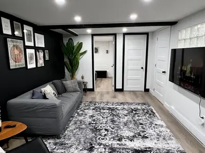 a living room with a couch and a tv at Edinburgh in Drummondville