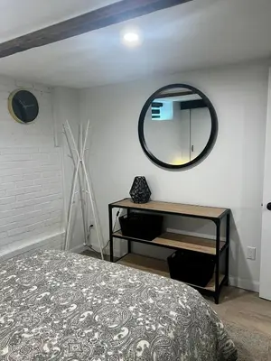 a bedroom with a bed and a mirror on the wall at Edinburgh in Drummondville