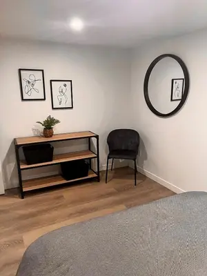 a room with a table and a chair and a mirror at Edinburgh in Drummondville