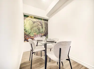 a dining room with a painting on the wall at Vivez la ville depuis le centre in Montréal