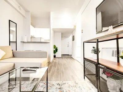 a living room with a couch and a table at Vivez la ville depuis le centre in Montréal