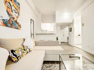 a living room with a couch and a glass table at Vivez la ville depuis le centre in Montréal