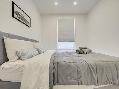 a bedroom with a large bed with a window at Confort moderne au cœur de Montréal in Montréal