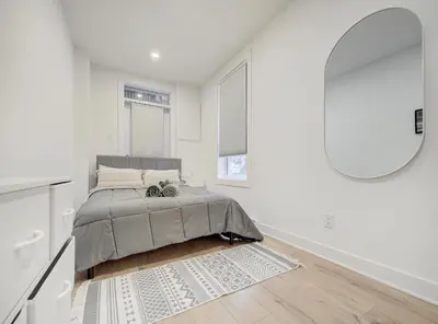 a bedroom with a bed and a large mirror at Confort moderne au cœur de Montréal in Montréal
