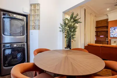 a dining room with a table and a microwave at Bright Montreal Loft, Trendy Downtown Escape in Montréal