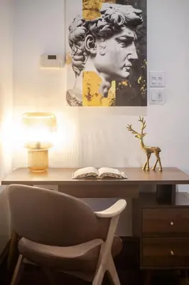 a desk with a chair and a picture of a head at Bright Montreal Loft, Trendy Downtown Escape in Montréal