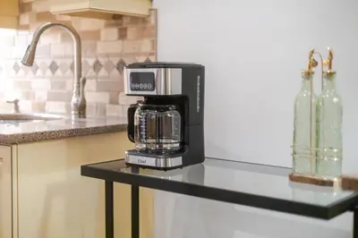 a coffee maker on a counter in a kitchen at Bright Montreal Loft, Trendy Downtown Escape in Montréal