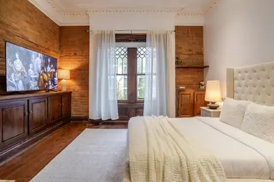 a bedroom with a large bed and a window at Bright Montreal Loft, Trendy Downtown Escape in Montréal
