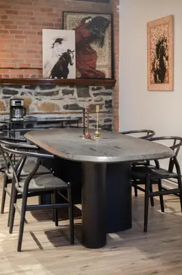 a table in a room with chairs and a brick wall at Downtown Montreal Gem, Walk Everywhere Easily in Montréal