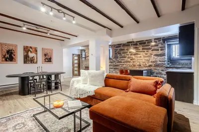 a living room with a couch and a table at Downtown Montreal Gem, Walk Everywhere Easily in Montréal