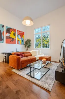 a living room with a couch and a glass table at Urban Haven, Modern Comfort in Downtown MTL in Montréal