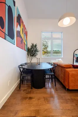 a living room with a table and a couch at Urban Haven, Modern Comfort in Downtown MTL in Montréal