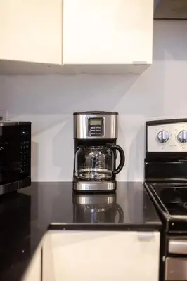 a coffee pot sitting on top of a kitchen counter at Urban Haven, Modern Comfort in Downtown MTL in Montréal