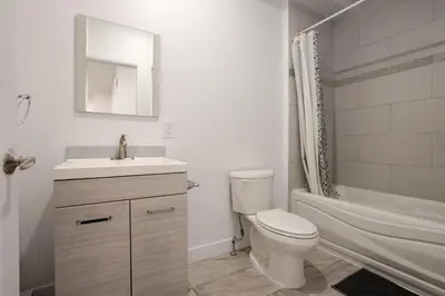 a bathroom with a toilet and a sink and a shower at Stylish Retreat Near Crescent & Sainte-Catherine in Montréal