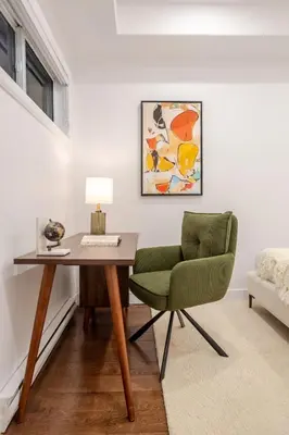 a desk and a green chair in a room at Stylish Retreat Near Crescent & Sainte-Catherine in Montréal