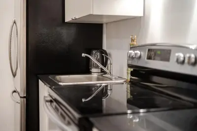 a kitchen with a sink and a stove at Stylish Retreat Near Crescent & Sainte-Catherine in Montréal