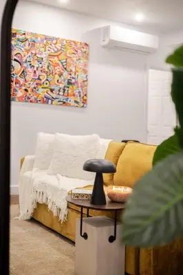 a living room with a couch and a table at Stylish Retreat Near Crescent & Sainte-Catherine in Montréal